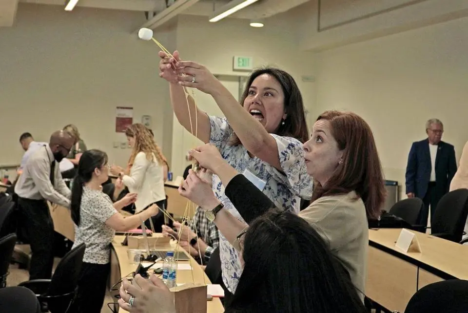 2023 Leadership Academy participants doing a marshmallow tower exercise