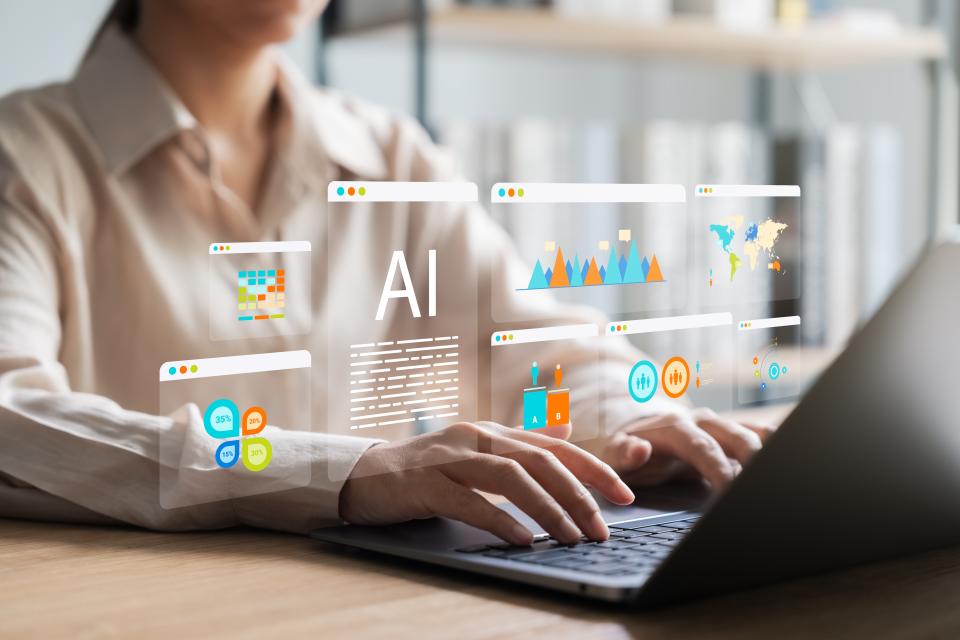 Woman typing on a laptop with digital graphics, including "AI" and data charts, overlaid to represent artificial intelligence and data analysis technology.