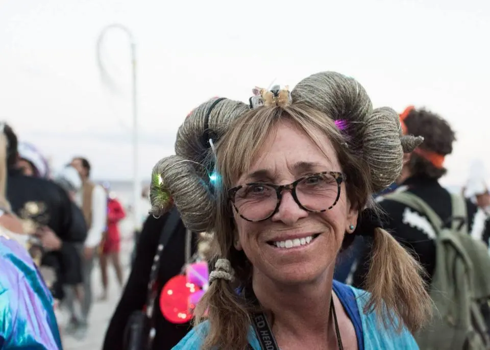 A woman with glasses and hair curlers