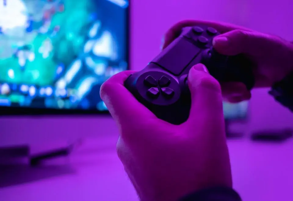 Hands holding a gaming controller