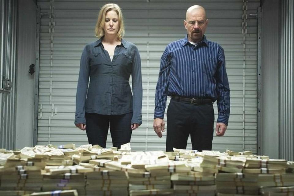 Walter White and his wife looking at a large pile of cash
