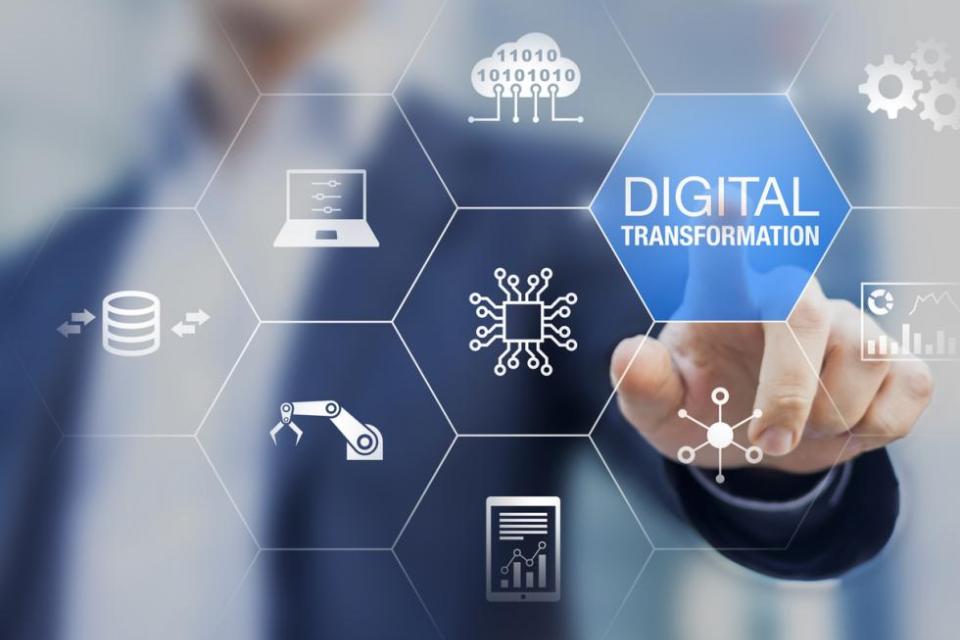 Businessman tapping digital transformation on futuristic hexagonal screen