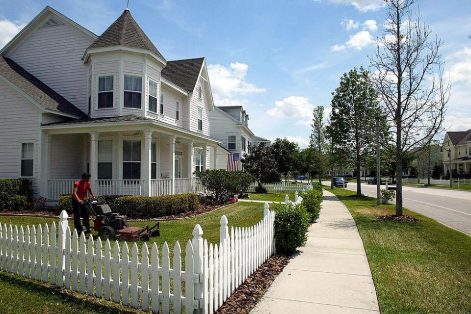 Suburban house with white picket fence
