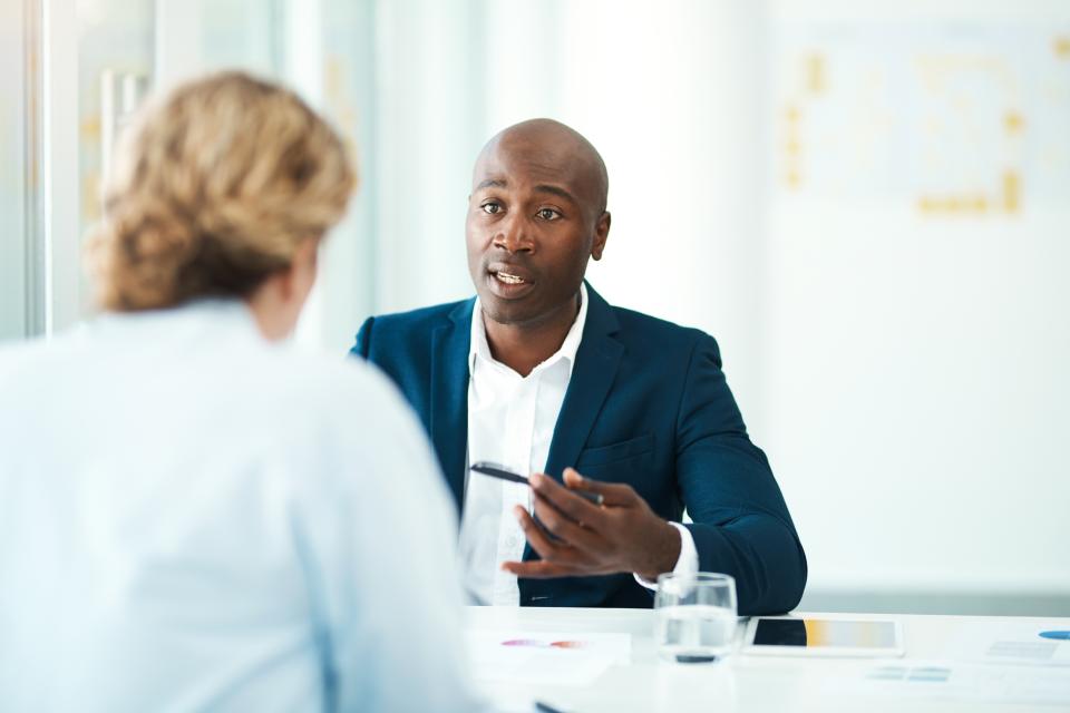 Man holding a pen talking