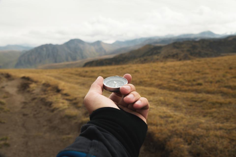 Hand holding a compass