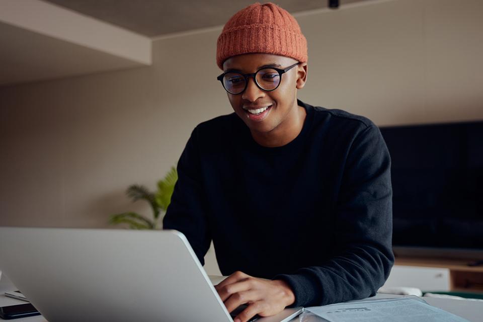 photo of a young man working on a notebook