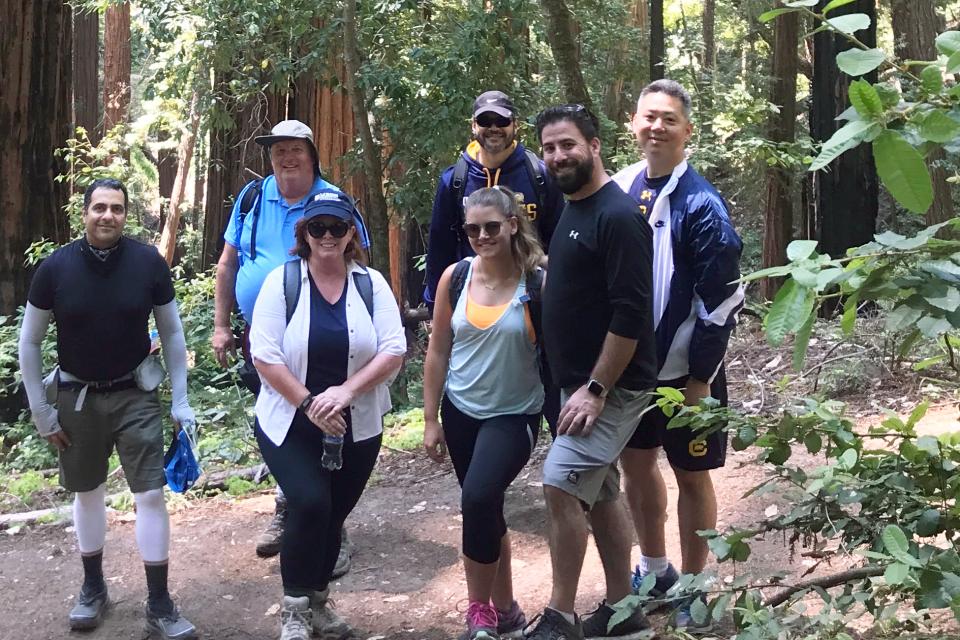 GSM alumni enjoying a hike on a woodsy trail.