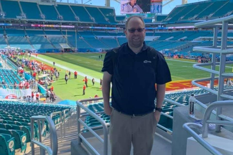 Joshua Hubbard in front of the football field while on assignment with ABC-7 to cover the Super Bowl