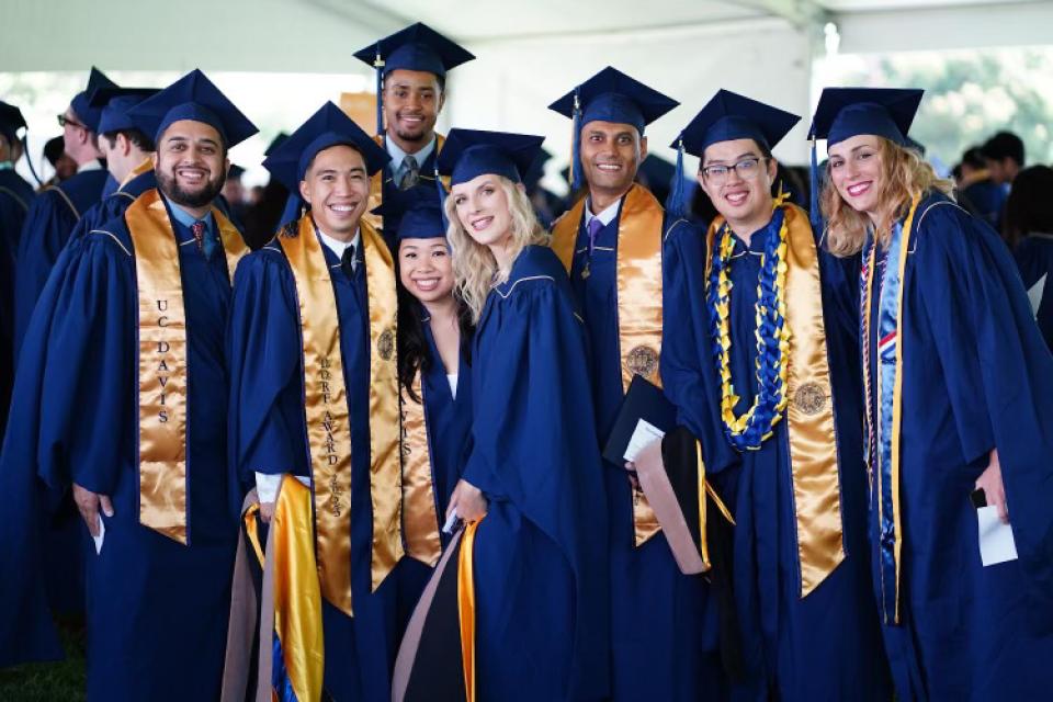 A group of Bay Area MBA students dressed in graduation caps and gowns