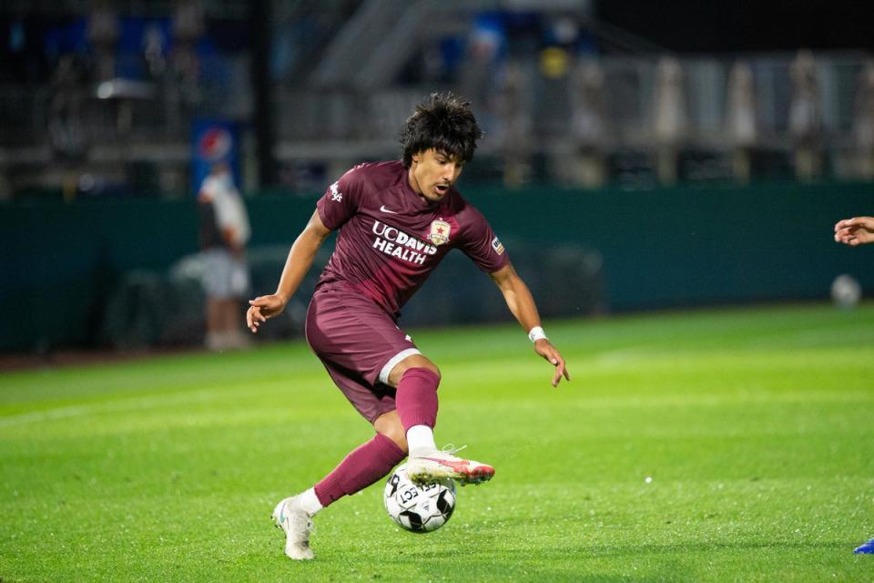 Sac Republic FC kicking a soccer ball during a game.