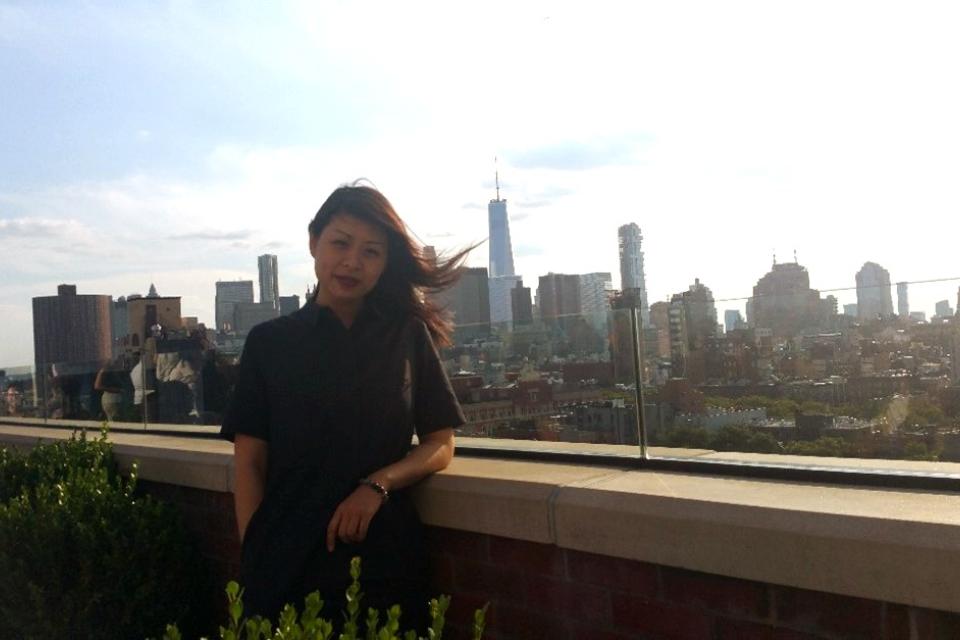 A photo of Faye Wu standing on a rooftop