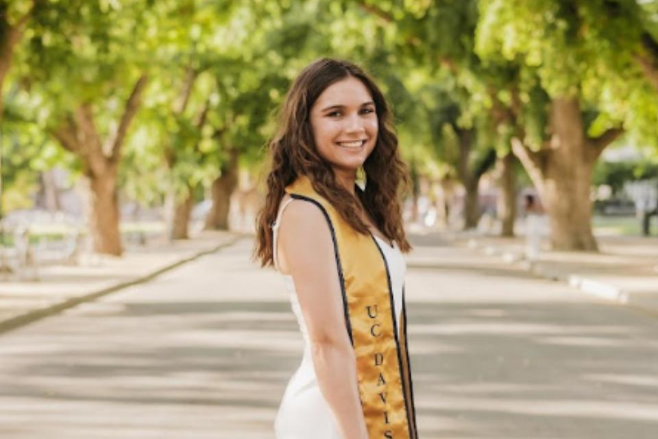 Kendall Richard wearing a graduation sash and cap