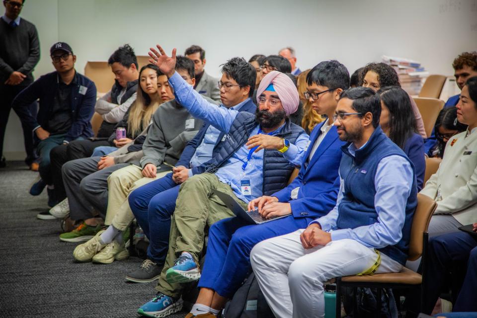 Jagdeep Singh Bachher sitting in a front row seat in a classroom