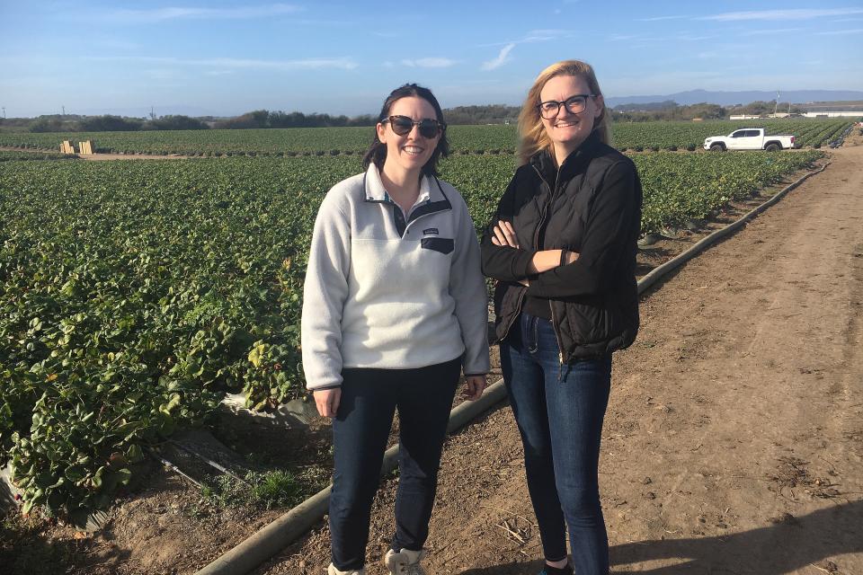 Two women standing in a field during a site visit