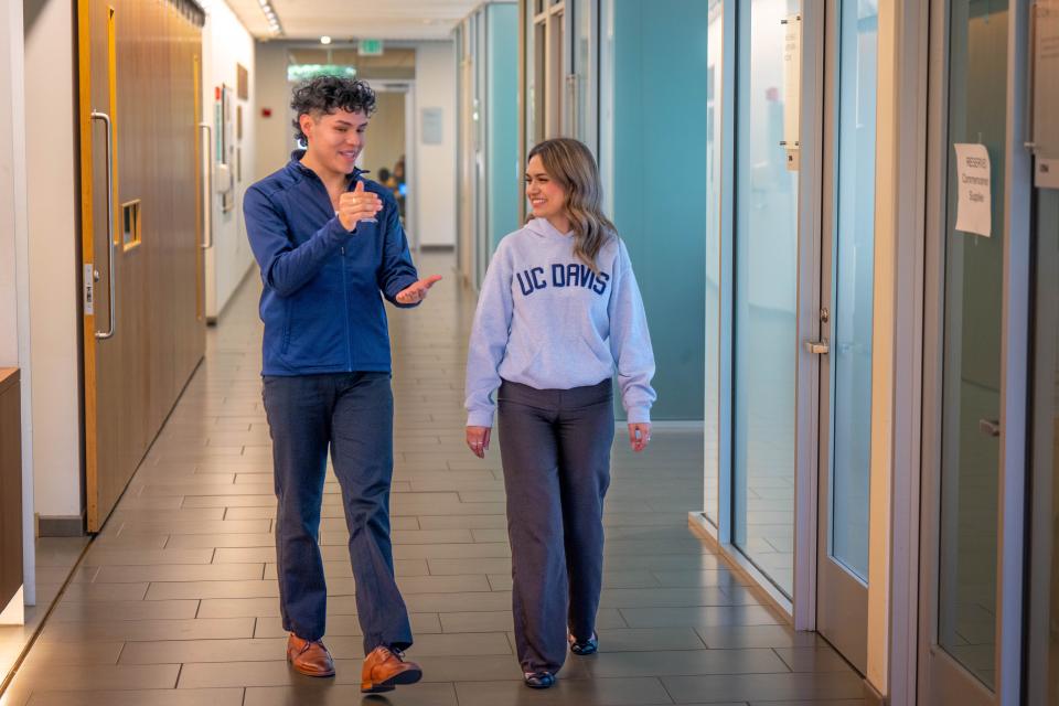 Two MPAc students walking in Gallagher Hall lobby