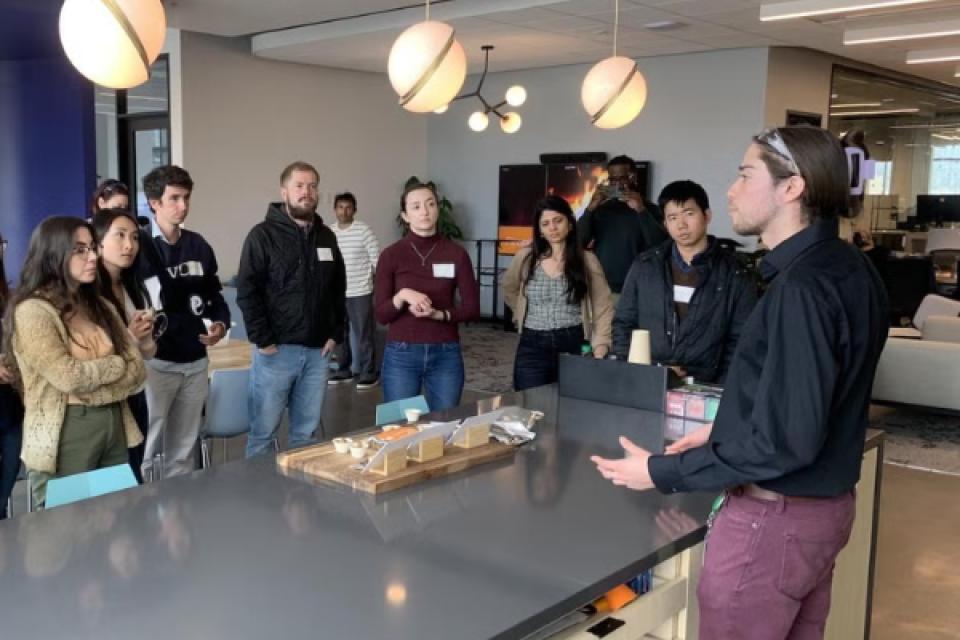 a group of students listening to a speaker demonstration
