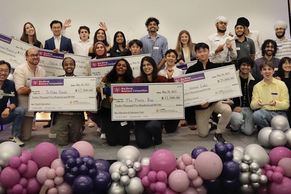 winners on stage with checks