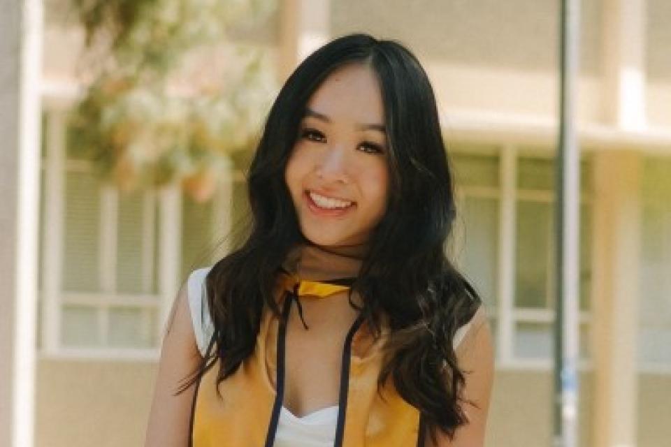 Diana Tran wearing a graduation stole
