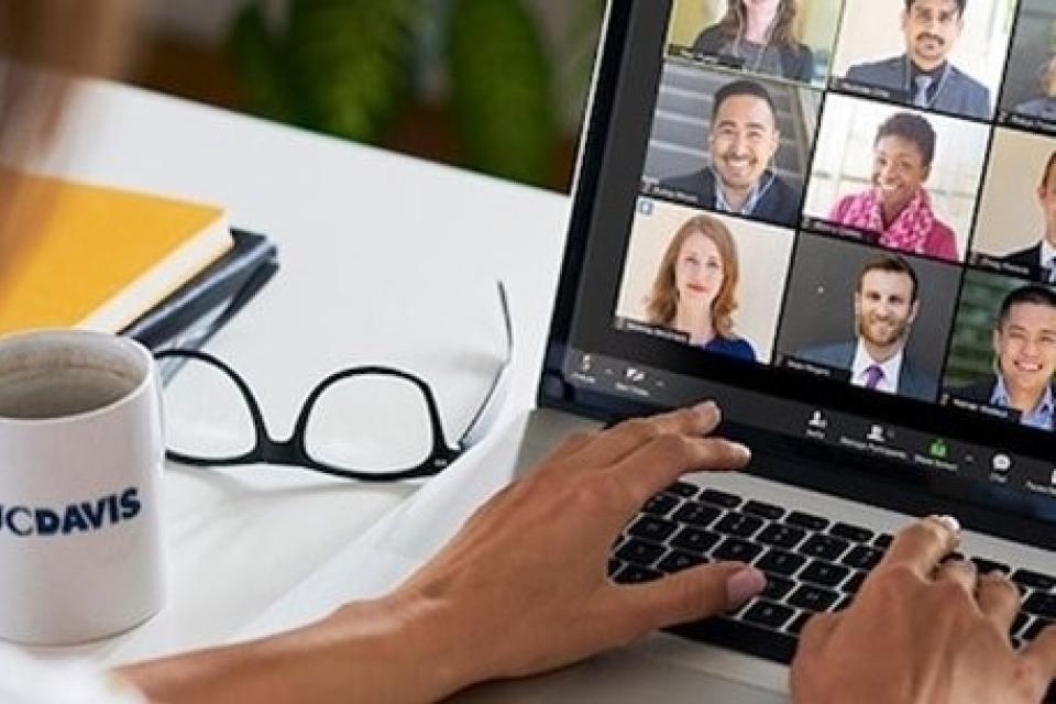 Person in an online meeting on a laptop
