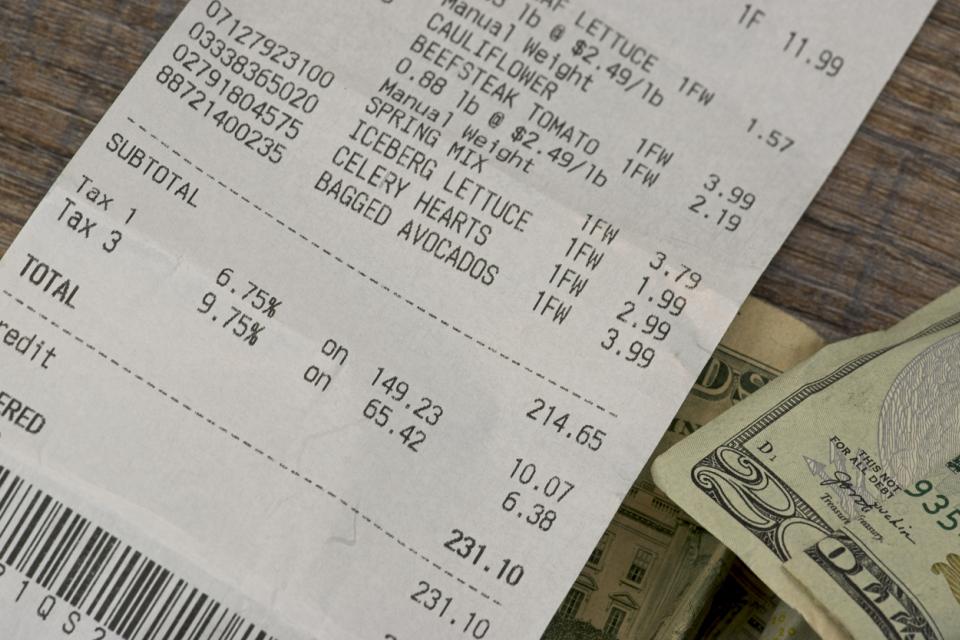 grocery receipt alongside $20 bills 
