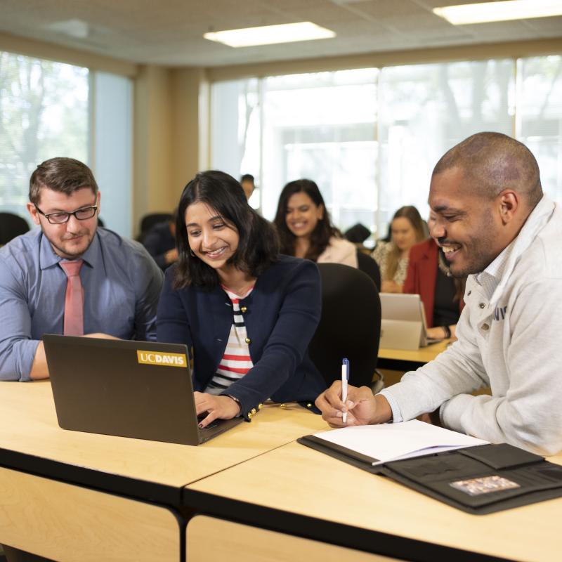 Group of people looking at a laptop